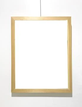 Golden frame hangs on string with empty interior space. Suspended border Stockfoto's