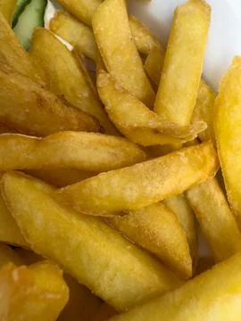 Golden fried potato chips serving delicious fast food snack Stock Photos