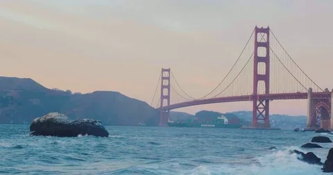 Golden gate bridge by Baker beach with a beautiful sunset and a crossing ship Video stock 69258065