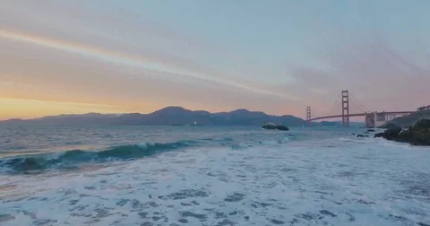 Golden gate bridge by Baker beach with a beautiful sunset and a crossing ship Video stock 69258124
