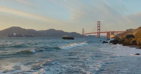 Golden gate bridge by Baker beach with a beautiful sunset and a crossing ship Video stock 69260904