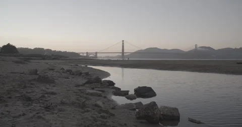 Golden Gate Bridge Beach at Sunset with Rocks Stock Footage 158775192