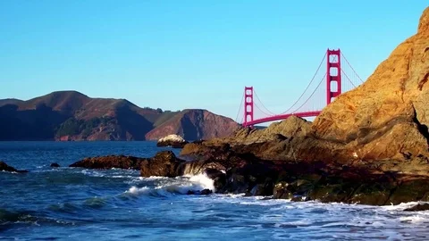 Golden Gate Bridge Over Waves Crashing Into Beach Mountainside by Aerial Drone 動画素材 70328807