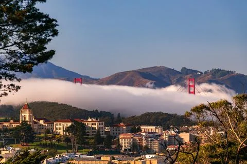 Golden Gate Bridge peeks out from the fog in San Francisco Stock Photos