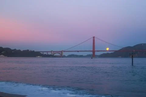 Golden Gate Bridge at twilight with a Eclipse moon rising! Stock Photos