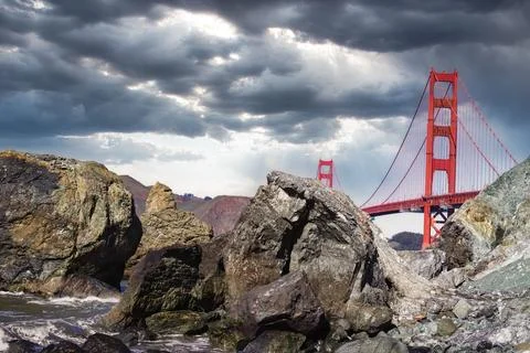 Golden Gate Bridge Under a Dramatic Sunlit Cloudy Sky Stock Photos