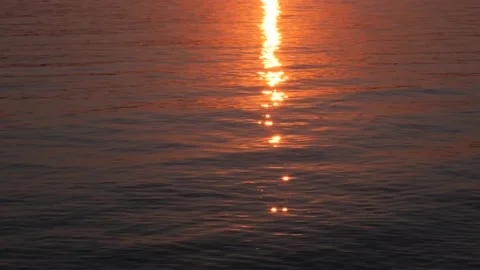 Golden glare on the surface of the blue waves from the setting sun Stock Footage 204719794