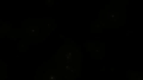 Golden glitter particles on black background. Abstract glowing stars floating Vídeos de archivo 340118829