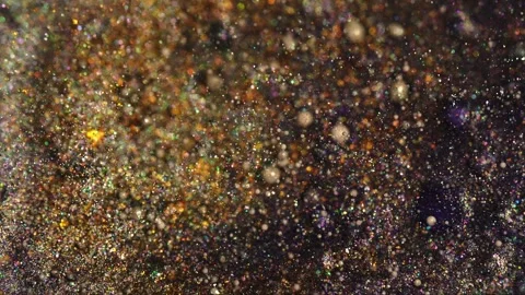 Golden glitter particles shimmer in macro close-up Stock Footage 311540589