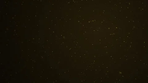 Golden glittering bokeh particles moving up on dark for luxury and award display Stock Footage 337236590