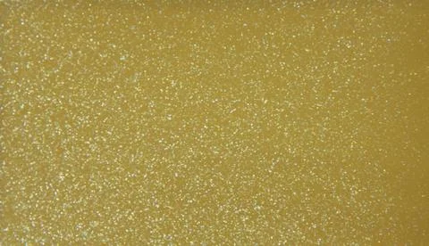Golden glossy plain background. Metallic. Texture. Close-up shot. Stock Photos
