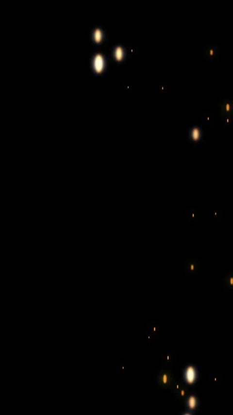 Golden glowing fire sparks falling against a dark black background Stockbeeldmateriaal 343075059