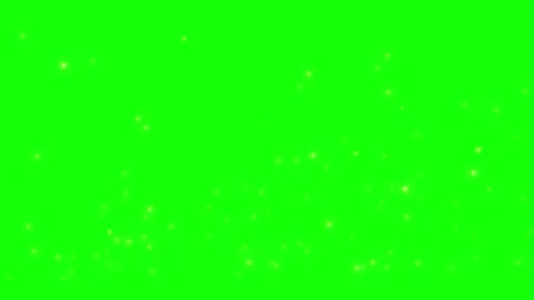 Golden glowing particles floating against vibrant green screen backdrop for Видео 344221053
