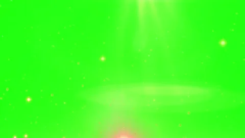 Golden glowing particles floating against vibrant green screen background for Stock Footage 345332368