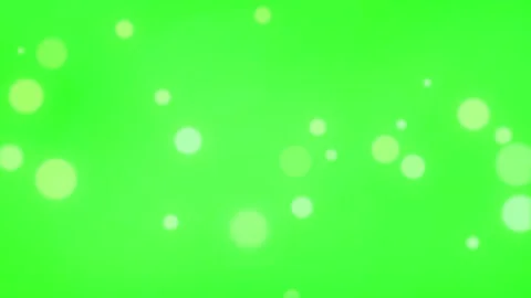 Golden glowing particles floating through vibrant green background with soft Stock-Footage 340012275