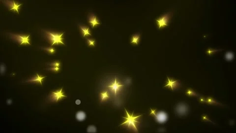 Golden glowing stars floating through dark atmosphere creating magical particle 動画素材 345101770