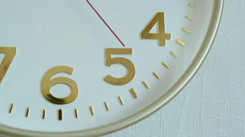 Golden hands of wall clock are moving slowly on a white face. Stock Footage 276762945