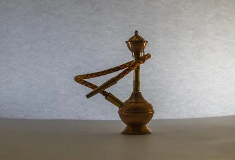 Golden hookah on lighted background Stock Photos