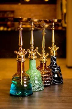 Golden hookahs on the table Stock Photos