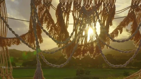 Golden Hour 4K Macrame &amp; String Lights Against Sunset, Rolling Hills View Stock Footage 323432771