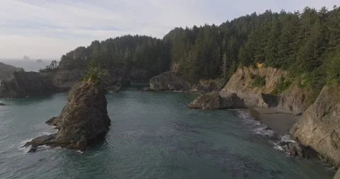 Golden Hour Aerial of Dramatic Cliffs and Green Waters Stock Footage 295252878