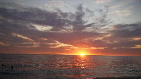 Golden hour casting warm light over tranquil thai coastline, silhouetted Stock Footage 308565854