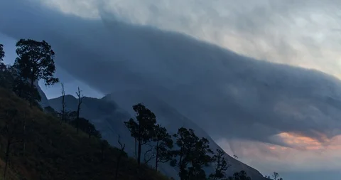Golden Hour Clouds Drifting over Tropical Mountain Peak (4K Time-lapse) Video stock 107907456