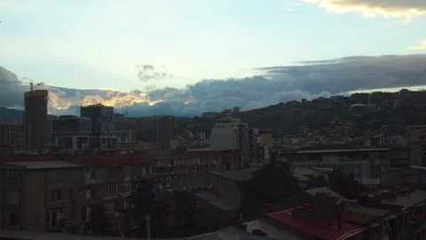 Golden hour clouds moving above tbilisi cityscape Video stock 340264089
