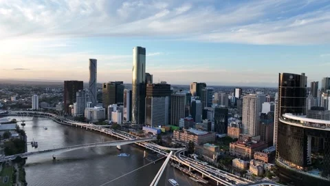 Golden hour drone pullback revealing Brisbane CBD and Queens Wharf skyline Stock Footage 331221478