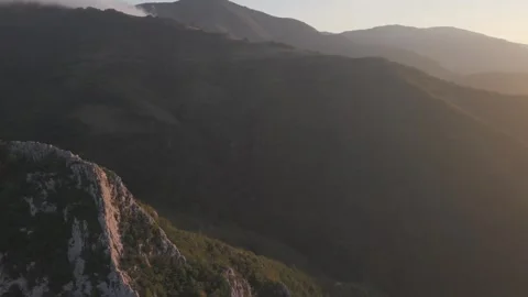 Golden Hour Flight Across Forest Mountains with Smooth Cinematic Camera Pan Stock Footage 337462149