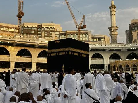 Golden Hour at Kaaba surrounded by the prayers in white ihram Stock Photos