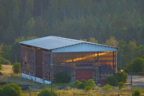Golden Hour Light of solar eclipse time illuminating large storage hall Stock Photos