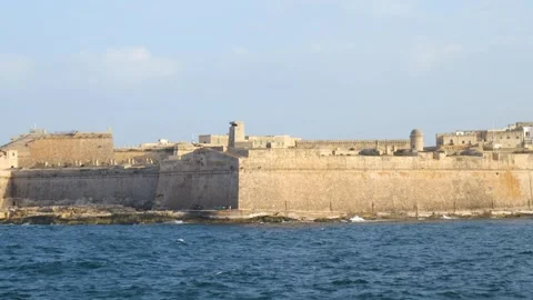 Golden hour light warms fort st elmo bastion walls rising from the sea evening Stock Footage 341807739