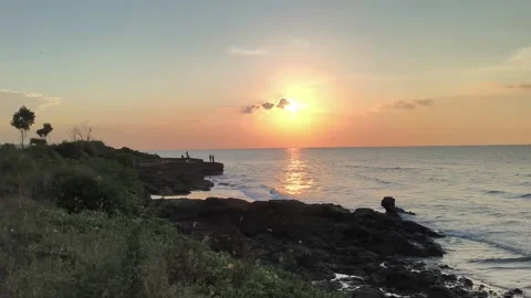 Golden Hour Ocean Sunset over Tropical Rocky Shore Stock Footage 340489663