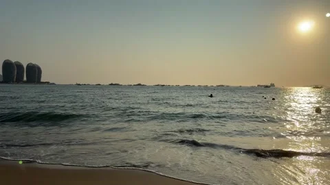 Golden Hour Ocean Waves with Phoenix Island Skyline in Sanya Video stock 330855113