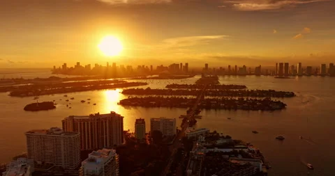 Golden hour over Brickell Key, Miami, USA. Bright sun reflects in the waterscape Stock Footage 323859336