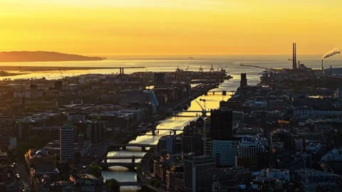 Golden Hour Over Dublin's River Liffey with Industrial Silhouette Stock Footage 332445656