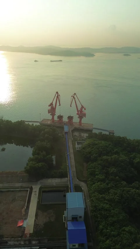 Golden hour serenity over an active industrial port: Towering cranes silhou.. Stock Footage 337281547