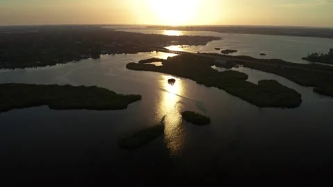 Golden Hour Sun Reflecting on Tidal Inlets and Marsh Islands in Florida Estuary Stock Footage 337523255