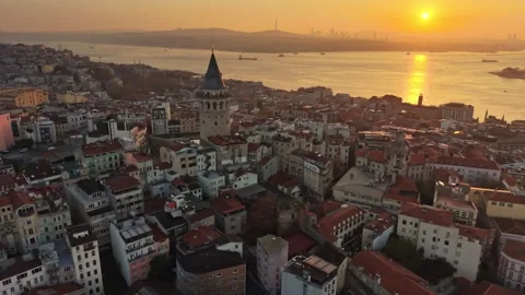 Golden hour sun sets behind iconic Galata Tower in Istanbul, Turkey Stock Footage 341750230