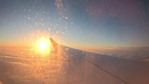 Golden hour sunlight flare through airplane window drops over cloud sea Stock-Footage 342533822