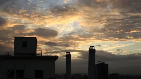 Golden hour sunset and clouds moving from the top of the building terrace Stock Footage 131357937