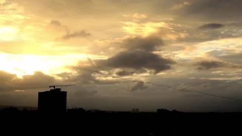 Golden hour sunset and clouds moving from the top of the building terrace Stock Footage 131357956