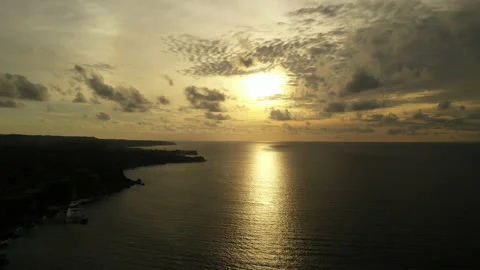 Golden Hour Sunset and Reflection on Sea with Wispy Clouds Stock Footage 205056633