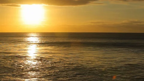 Golden hour sunset with bright reflection over romantic evening ocean A Stock Footage 120400246