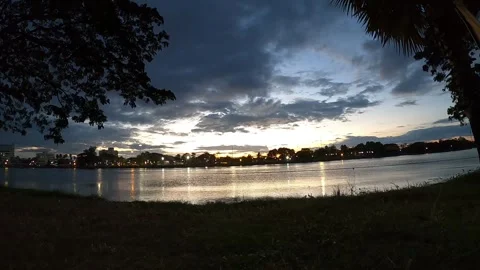 Golden Hour Sunset Cityscape Reflection with Boat Crossing Calm Lake Water. Stock Footage 321380937