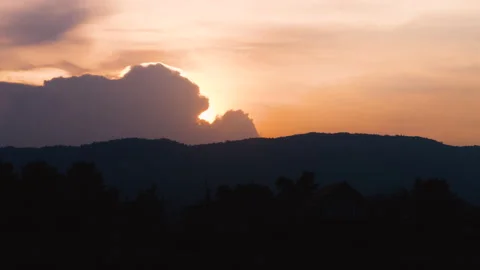 Golden-hour sunset with clouds moving across the sky Stock Footage 283417852