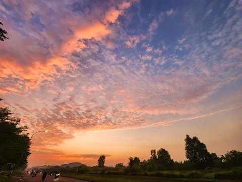 Golden hour sunset with dramatic clouds and view of nature's beauty Stock Photos