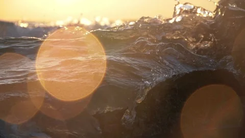 Golden hour sunset ocean waves crashing with bright lens flare. Stock Footage 342714489