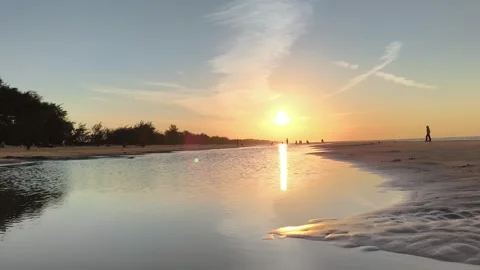 Golden Hour Sunset Reflection on Tropical Sandy Beach Silhouettes Stock Footage 340216023